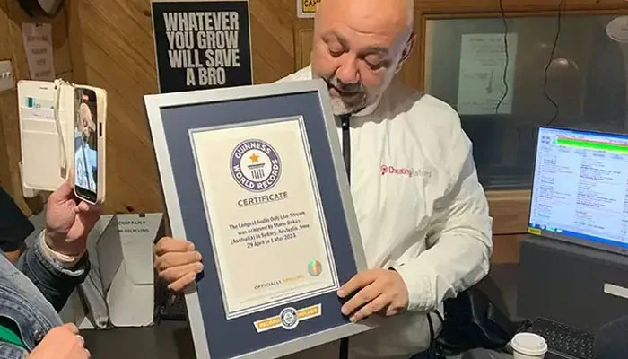 Mario Bekes holds his Guinness World Record Plaque