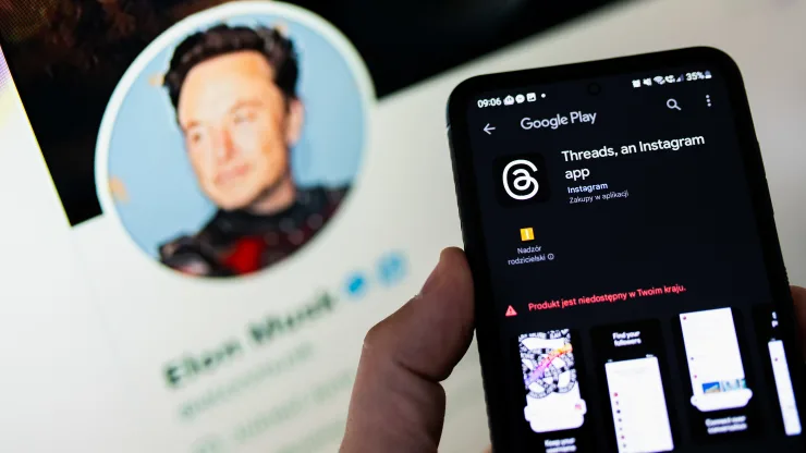 Threads-logo-seen-displayed-on-a-smartphone-with-the-Twitter-profile-of-Elon-Musk-in-the-background.-Elon-Musk-is-the-current-owner-of-Twitter