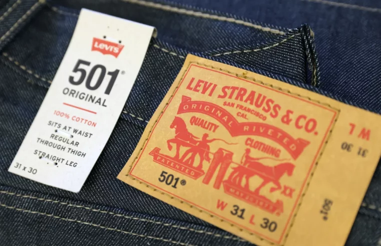 Levi Strauss cuts annual forecasts as promotions