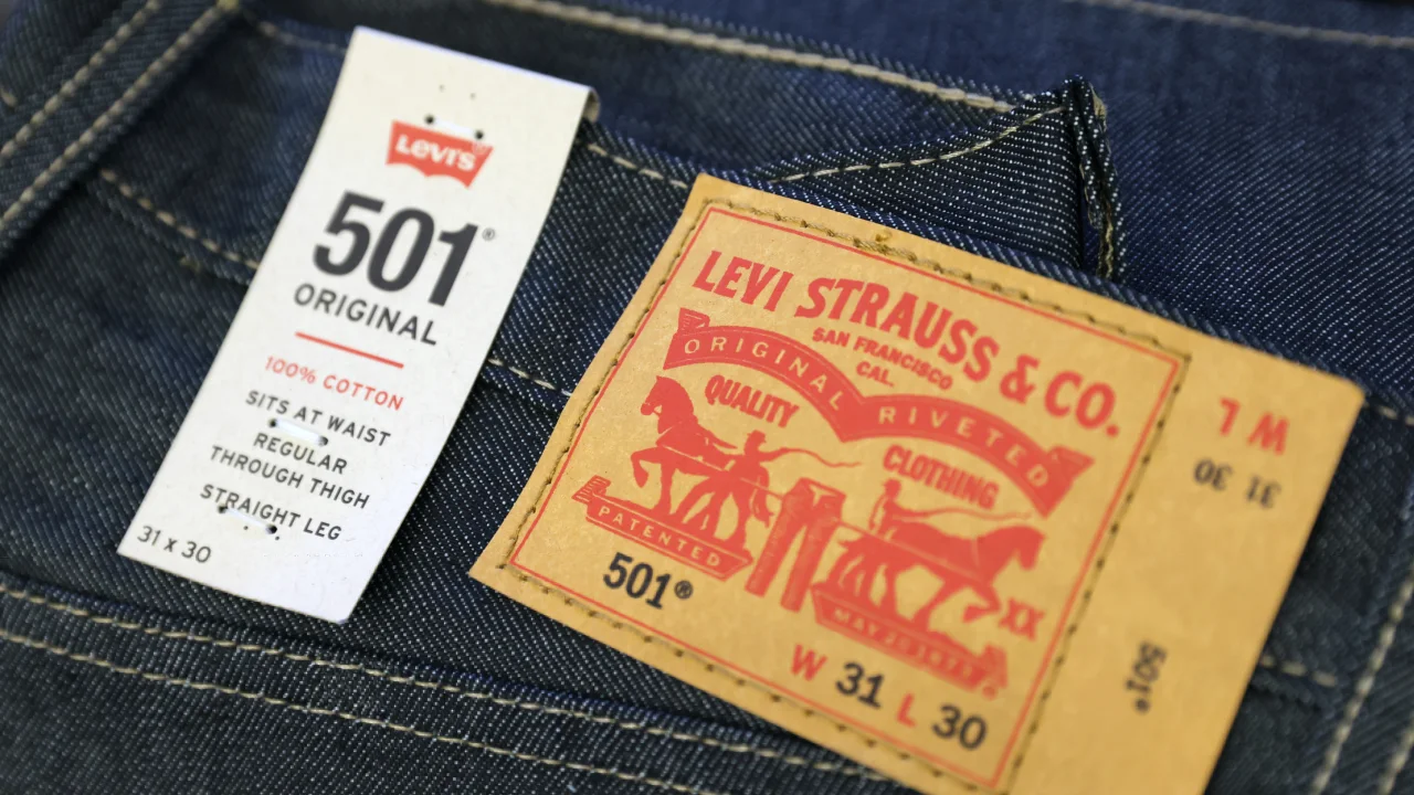 Levi Strauss cuts annual forecasts as promotions